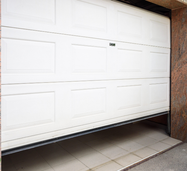 Professional technician performing comprehensive garage door safety inspection in San Francisco Bay Area home