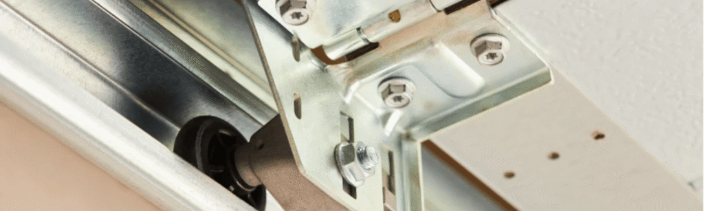 Technician replacing worn garage door roller on residential door in San Francisco Bay Area garage