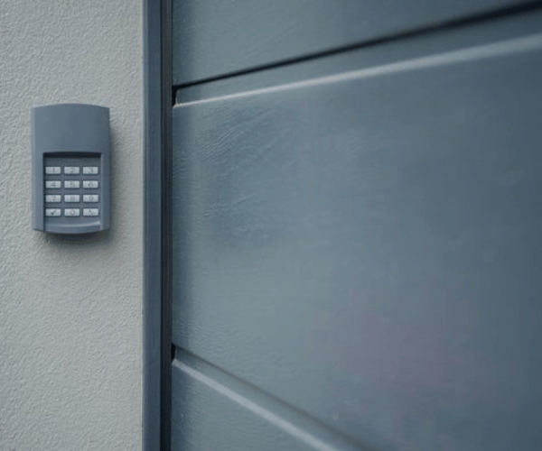 Technician programming wireless garage door keypad for customer in San Francisco Bay Area home